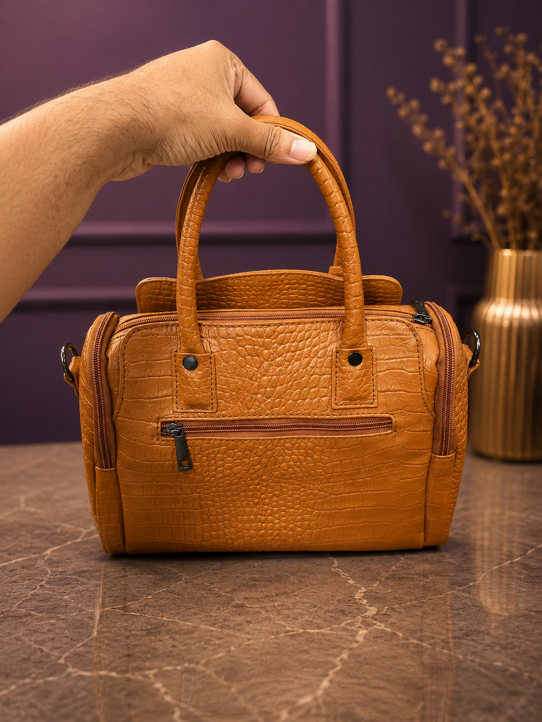 Back view of croco texture tan handbag showing rear zip pocket and dual top handles