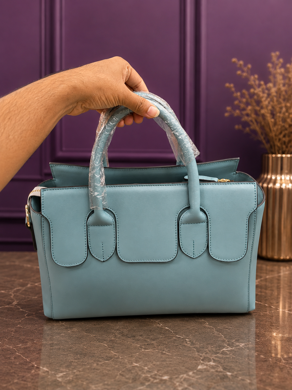 Sky blue structured handbag with purple background