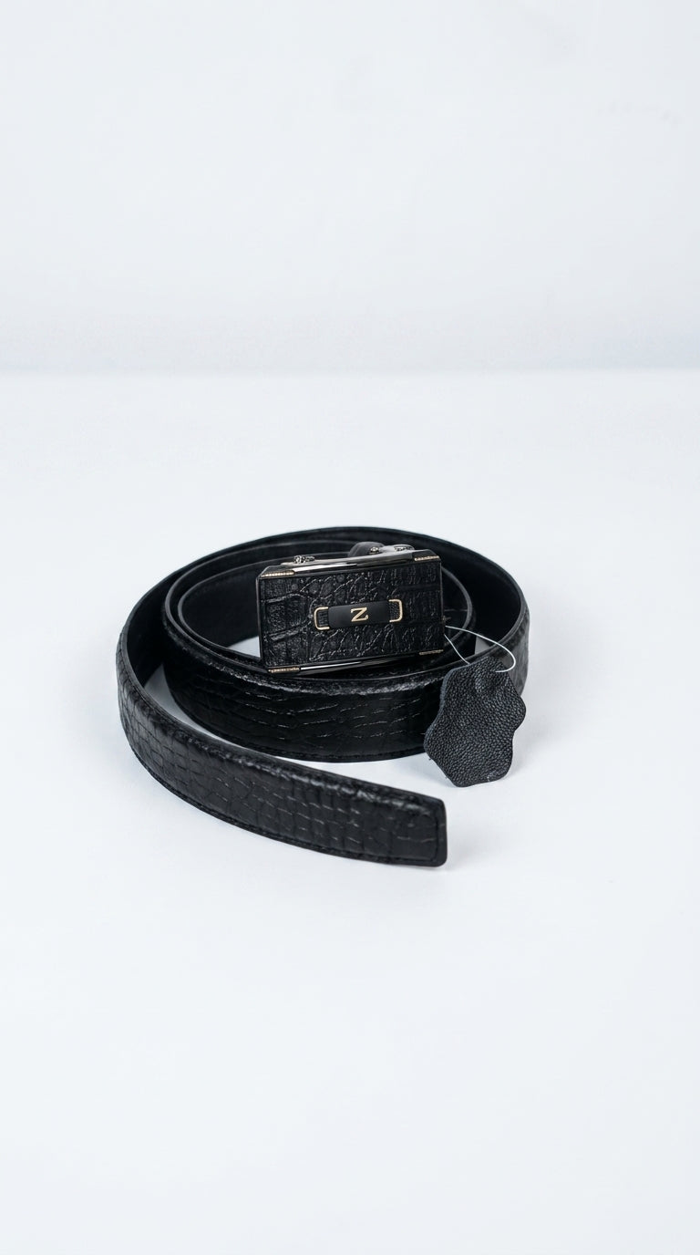 A black crocodile-embossed leather belt with a textured metal buckle, coiled on a light gray background.